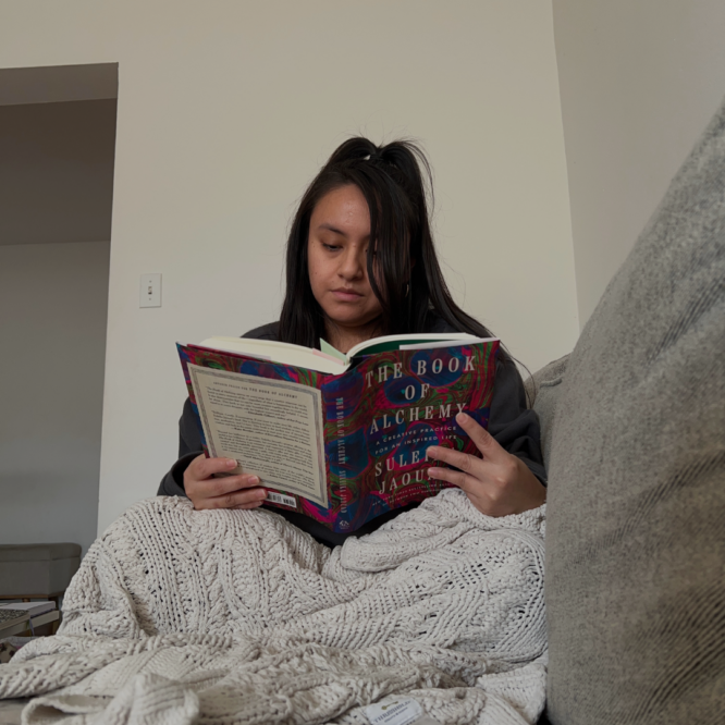 woman reading book of alchemy