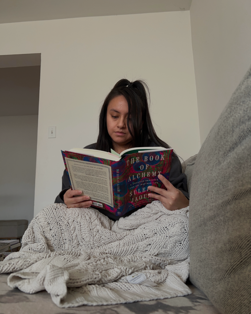 woman reading book of alchemy