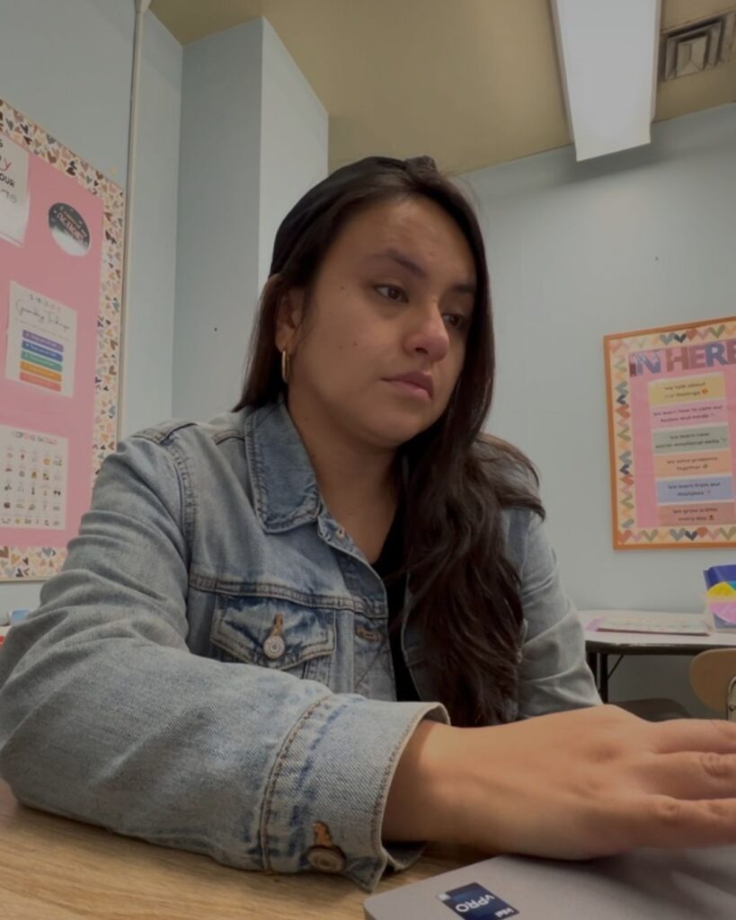 Sitting at my desk looking unhappy while working as a school counselor.