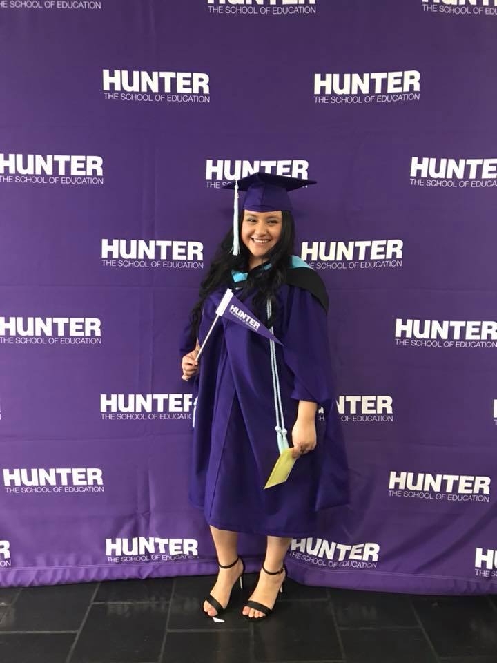 Graduating with my Master’s degree in School Counseling, smiling in cap and gown